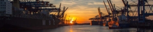 Sonnenuntergang im Containerhafen mit Kränen und einigen Schiffen - MSC